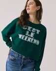 Front view of woman wearing Chaser’s Blue Grass Green C’est Le Weekend Long Sleeve with text on a plain background