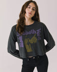 Woman wearing Chaser's black oversized Black Sabbath Vol 4 Long Sleeve top with a graphic design, black pants on a white background