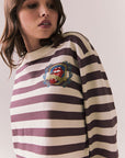 Side view of The Rolling Stones Rugby Stones Logo Long Sleeve with red and white stripes, cropped fit, and tongue logo graphic against a plain background
