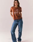 Full body shot of model in Wild Horses tee and denim.