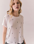Front view of Tossed Bolts short sleeve tee in white with scattered black lightning bolt graphic and relaxed fit against a plain background