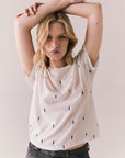 Front view of Tossed Bolts short sleeve tee in white with scattered black lightning bolt graphic and relaxed fit against a plain background