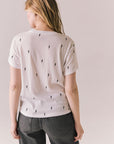 Back view of Tossed Bolts short sleeve tee in white with scattered black lightning bolt graphic and relaxed fit against a plain background