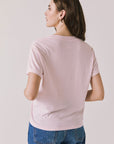 Back view of woman wearing Chaser’s Semi Sweet Pink Tee on a light background