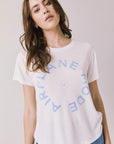 Woman wearing the Airplane Mode Tee with blue text on a plain background