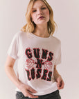 White graphic tee with flaming Guns N’ Roses logo and floral artwork.
