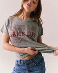 Gray short sleeve tee with maroon graphic text and relaxed fit.