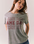 Gray short sleeve tee with maroon graphic text and relaxed fit.