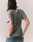 Back view of model wearing Wildcat Spirit Tee in Heather Grey with maroon wildcat chest graphic against a plain background