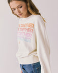 Side view of woman wearing Chaser’s The Beatles Come Together Starry White Long Sleeve on a plain background