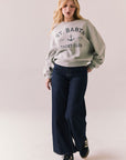 Full body view of model in St. Barth Yacht Club Pullover styled casually with jeans.