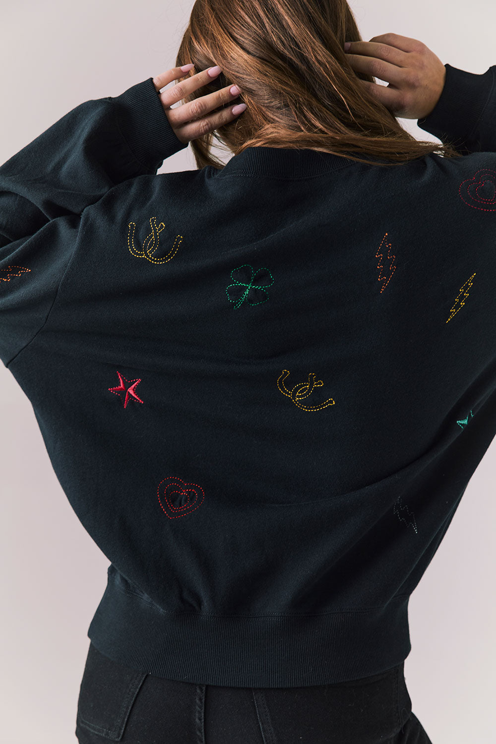 Back view of model wearing Allover Icons Long Sleeve in black