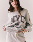 Front view of NYC Stars Pullover in Heather Grey with bold chest lettering and black star sleeves against a plain background