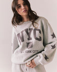 Front view of NYC Stars Pullover in Heather Grey with bold chest lettering and black star sleeves against a plain background
