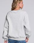 Model wearing Chaser's Merry Bow Pullover in Heather Grey with oversized red bow artwork, back view