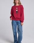Model wearing Chaser's Coca-Cola Holiday Coke Pullover in Winter Garnet red with vintage Coca-Cola bottle artwork, full-body view