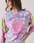 Front view of woman wearing Chaser’s Grateful Dead Rose Logo Long Sleeve with tie-dye pattern on a plain background