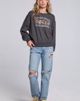 Model wearing Chaser's Grateful Dead 'Tis the Season Pullover in Fresh Gravel with colorful Grateful Dead holiday artwork, full-body view