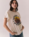Side view of model wearing the Jackson Hole Sunset Tee in white with scenic Western graphic with graphic design on a plain background