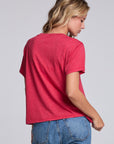 Model wearing Chaser's Cheers Tee in Cherry Bomb red with French-style celebratory lettering, back view