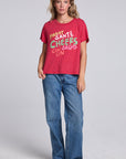 Model wearing Chaser's Cheers Tee in Cherry Bomb red with French-style celebratory lettering, full-body view