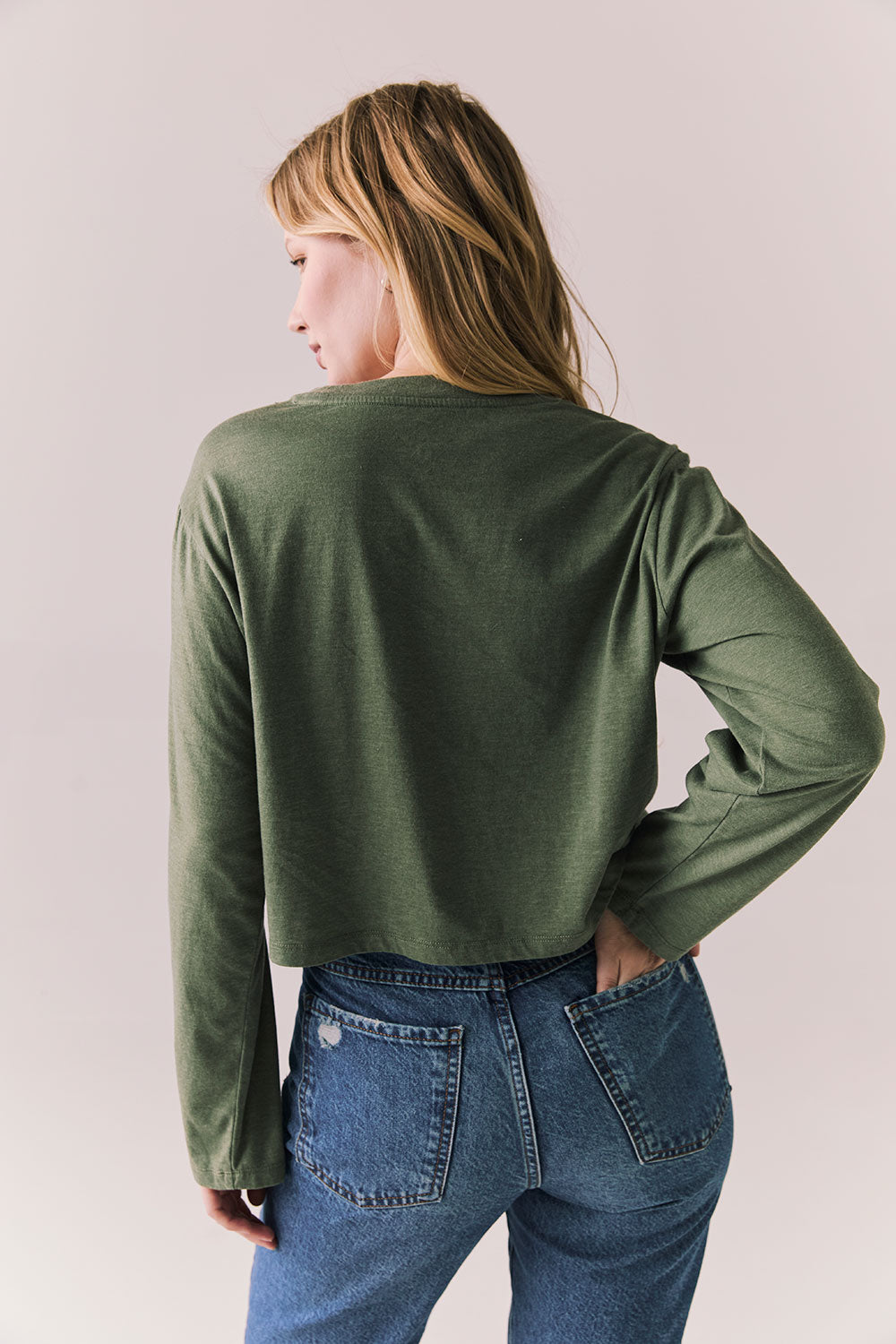 Back view of womens wearing Chaser's Classics Motors washed bronze green long sleeve with retro graphic on a plain background