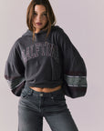 Front view of model wearing the Halftime fleece pullover hoodie in True Black with ‘HALFTIME’ chest graphic, against a plain background.