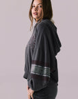 Side view of model wearing the Halftime fleece pullover hoodie in True Black with ‘HALFTIME’ chest graphic, against a plain background.