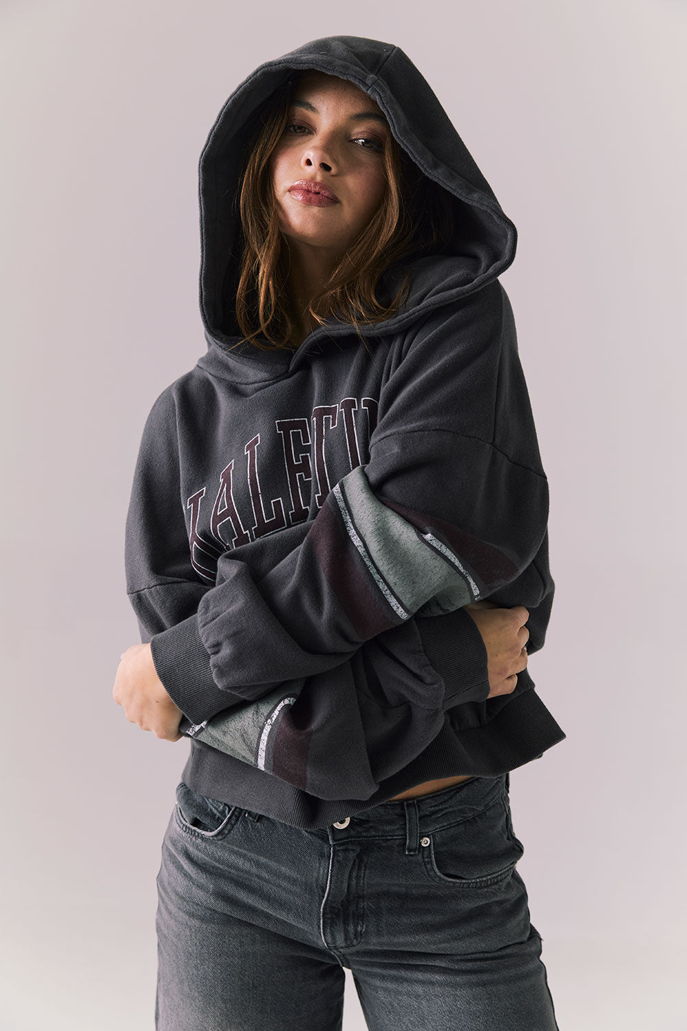 Front view of model wearing the Halftime fleece pullover hoodie in True Black with ‘HALFTIME’ chest graphic, against a plain background.