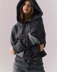 Front view of model wearing the Halftime fleece pullover hoodie in True Black with ‘HALFTIME’ chest graphic, against a plain background.