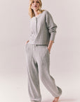 Side full view of Thayne cropped thermal henley top in Heather Grey with 3/4 button placket and ribbed texture and matching Billy Joggers against a plain background