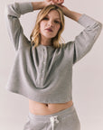 Front view of Thayne cropped thermal henley top in Heather Grey with 3/4 button placket and ribbed texture against a plain background