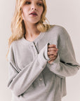 Front view of Thayne cropped thermal henley top in Heather Grey with 3/4 button placket and ribbed texture against a plain background