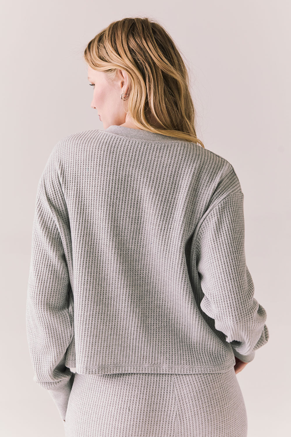 Back view of Thayne cropped thermal henley top in Heather Grey with 3/4 button placket and ribbed texture against a plain background