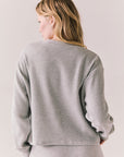 Back view of Thayne cropped thermal henley top in Heather Grey with 3/4 button placket and ribbed texture against a plain background