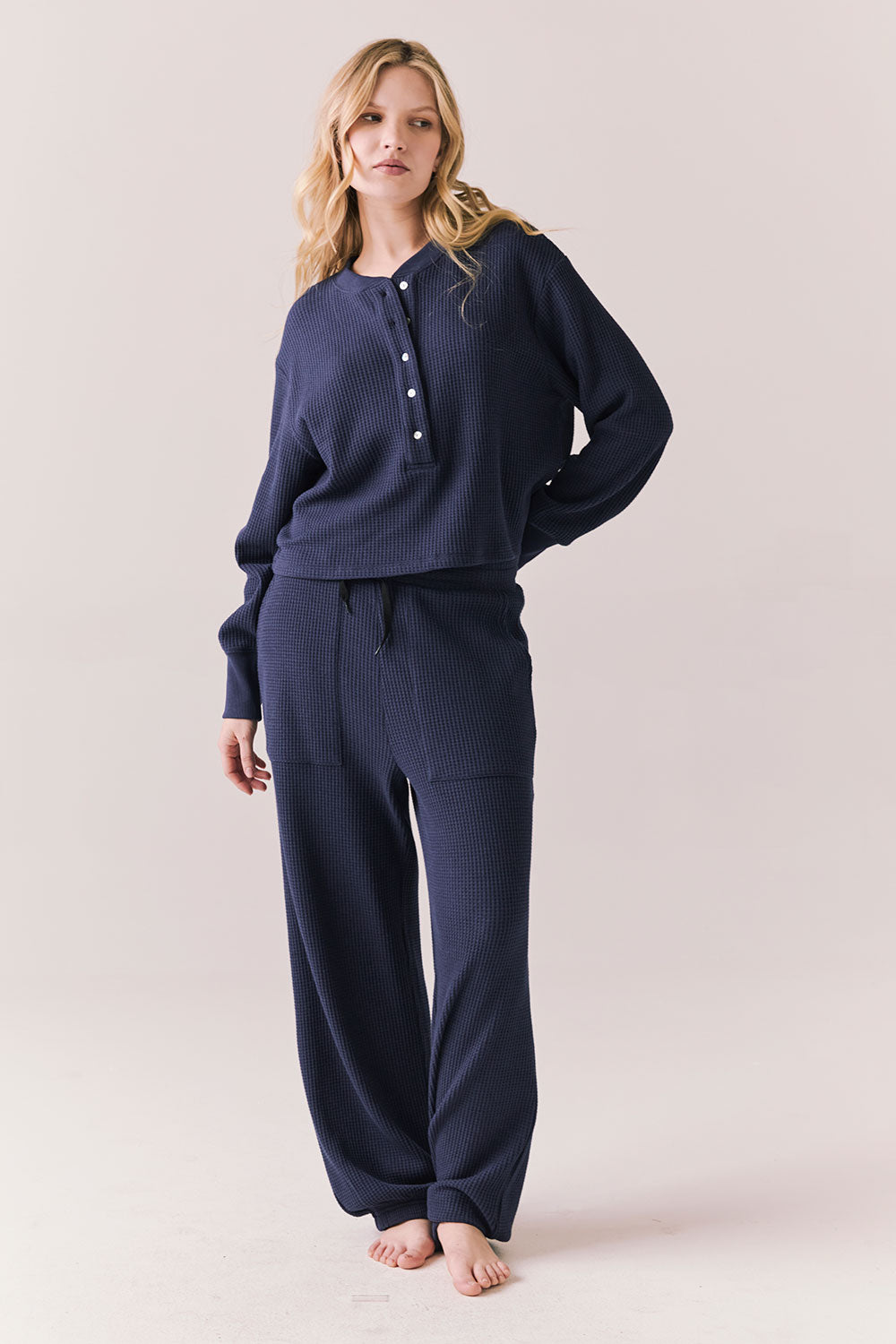 Full front view of Thayne cropped thermal henley top in Midnight Blue with 3/4 button placket and ribbed texture with matching Billy Joggers against a plain background