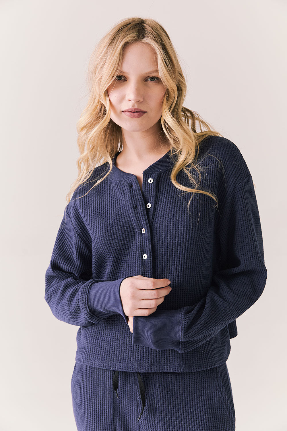 Front view of Thayne cropped thermal henley top in Midnight Blue with 3/4 button placket and ribbed texture against a plain background
