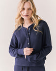 Front view of Thayne cropped thermal henley top in Midnight Blue with 3/4 button placket and ribbed texture against a plain background