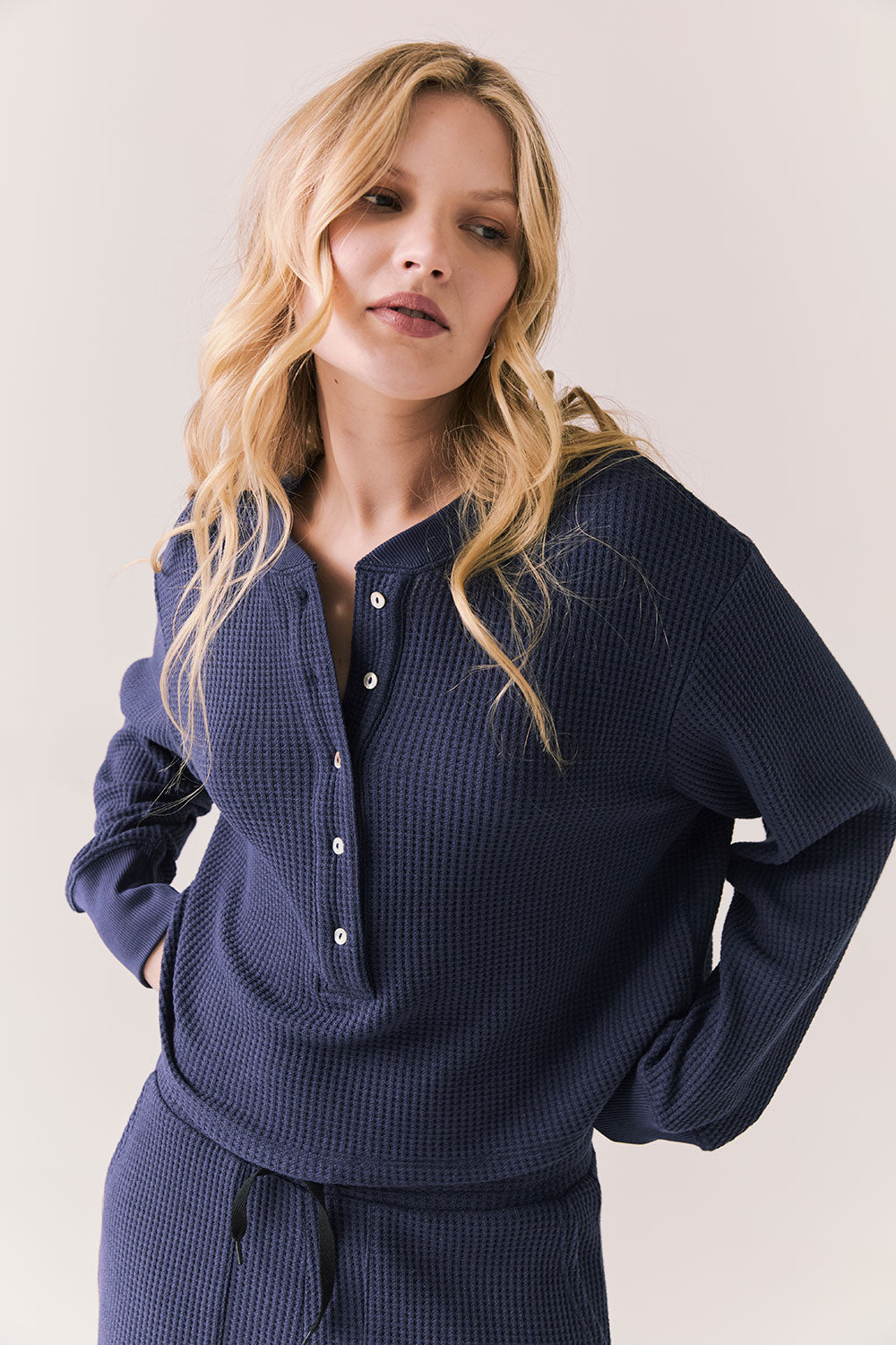 Front view of Thayne cropped thermal henley top in Midnight Blue with 3/4 button placket and ribbed texture against a plain background