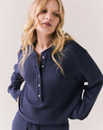 Front view of Thayne cropped thermal henley top in Midnight Blue with 3/4 button placket and ribbed texture against a plain background
