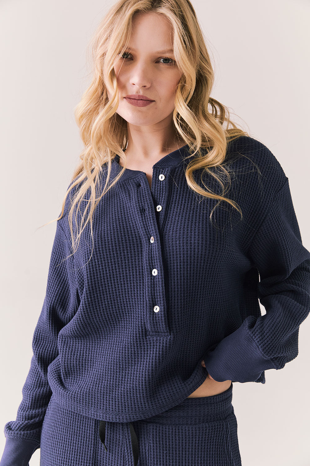 Front view of Thayne cropped thermal henley top in Midnight Blue with 3/4 button placket and ribbed texture against a plain background