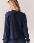 Back view of Thayne cropped thermal henley top in Midnight Blue with 3/4 button placket and ribbed texture against a plain background