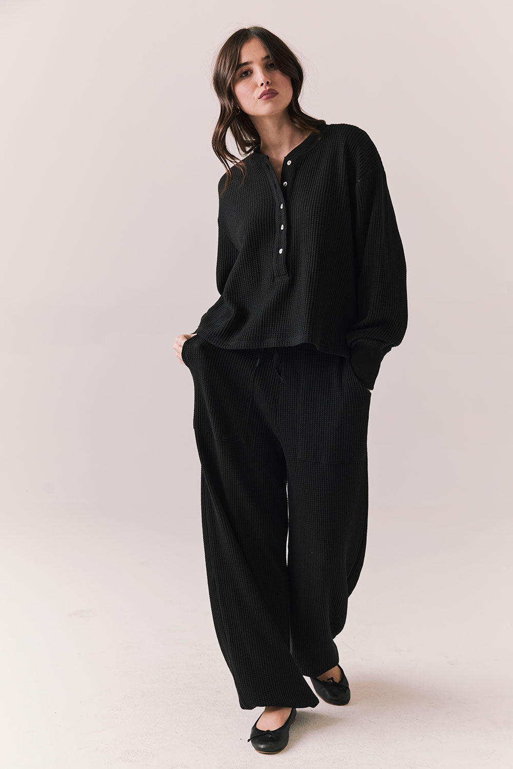 Full body view of model wearing Thayne Long Sleeve in True Black with matching Billy Joggers against a plain background.