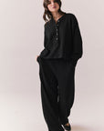 Full body view of model wearing Thayne Long Sleeve in True Black with matching Billy Joggers against a plain background.