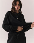Front view of Thayne Long Sleeve in True Black with cropped fit, henley placket, and ribbed texture against a plain background