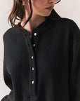 Closeup front view of Thayne Long Sleeve in True Black with cropped fit, henley placket, and ribbed texture against a plain background