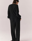 Back full body view of model wearing Thayne Long Sleeve in True Black with matching Billy Joggers against a plain background