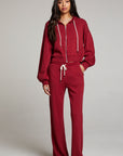 Full body view of model wearing Abilenee Blood Red Zip Up Hoodie paired with Sandyy Trousers against a plain background