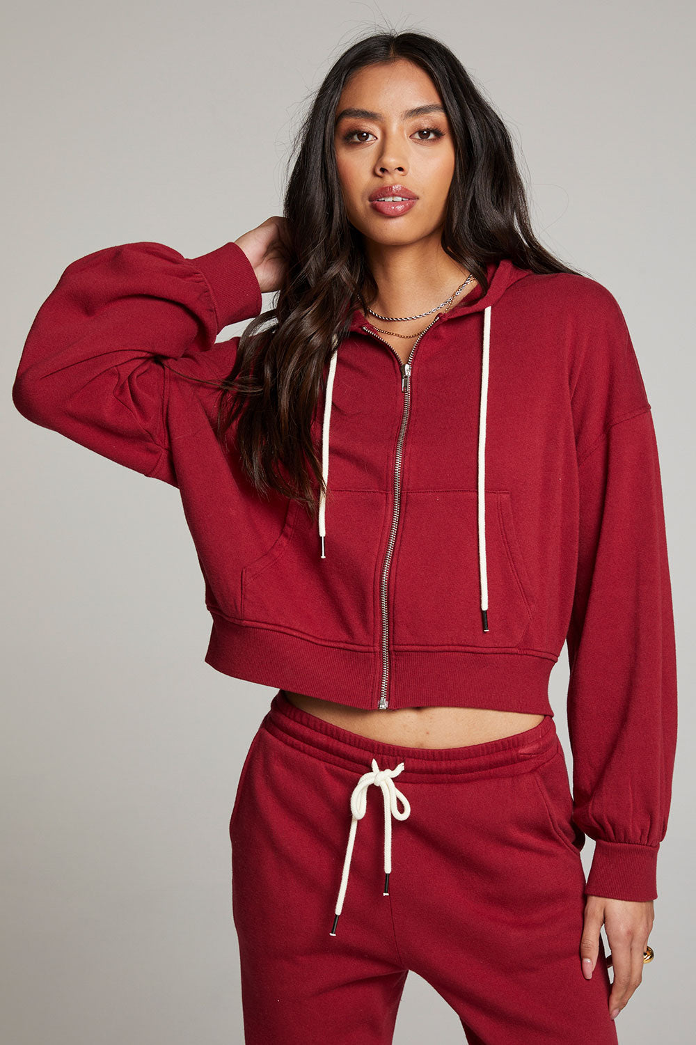 Front view of model wearing Abilenee Blood Red Zip Up Hoodie with cropped hem and full-zip closure against a plain background