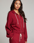 Side view of model wearing Abilenee Blood Red Zip Up Hoodie with cropped hem and full-zip closure against a plain background
